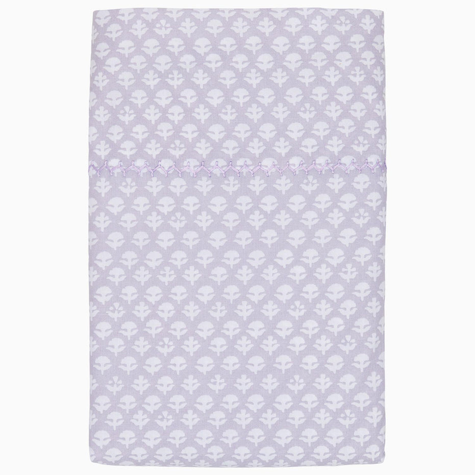 A John Robshaw Bindi Lavender Organic Sheet Set with a white pattern on it.