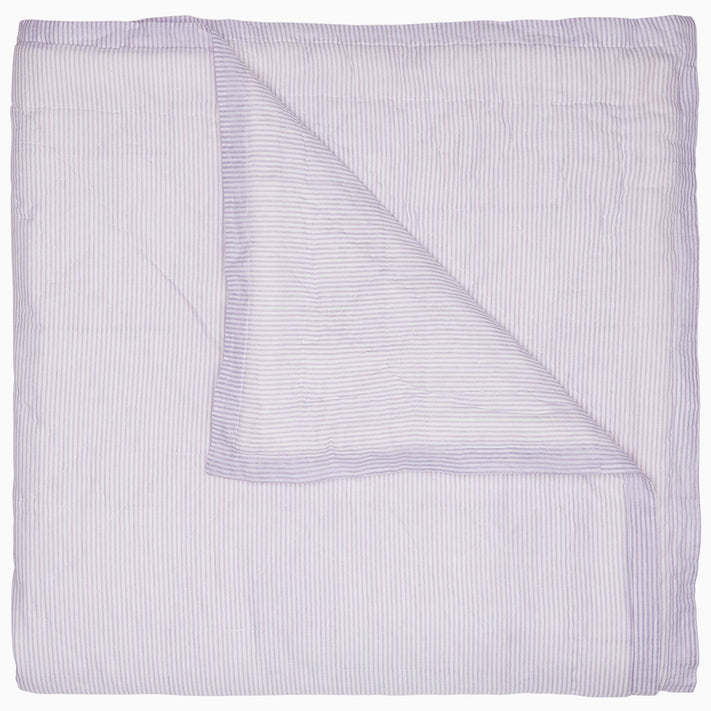 A Nandi Lavender Quilt, made by John Robshaw, on a white background, made of cotton.