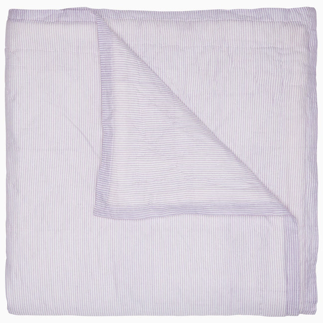 A Nandi Lavender Quilt, made by John Robshaw, on a white background, made of cotton.