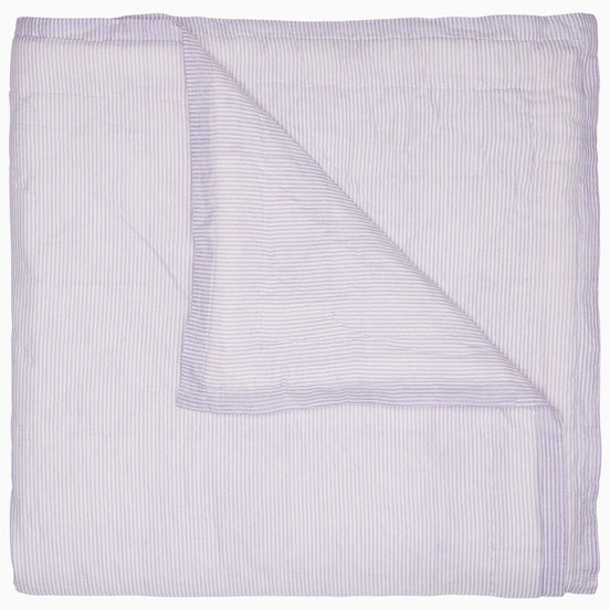 A Nandi Lavender Quilt, made by John Robshaw, on a white background, made of cotton.
