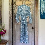 A Shristi Robe in blue and white paisley cotton voile hanging on an old door.
Brand: Sleepwear. - 30437794480174