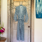 A blue and white Aaditya Robe, made in India, hanging on a door. - 30437792546862