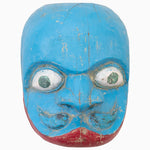 A John Robshaw Blue Demon Mask from India featuring blue color and red eyes, displayed on a white background. - 30497652867118