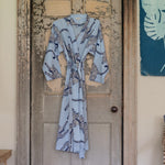 A blue and white cotton voile Dabeet Robe by John Robshaw hanging on a door. - 30822535954478