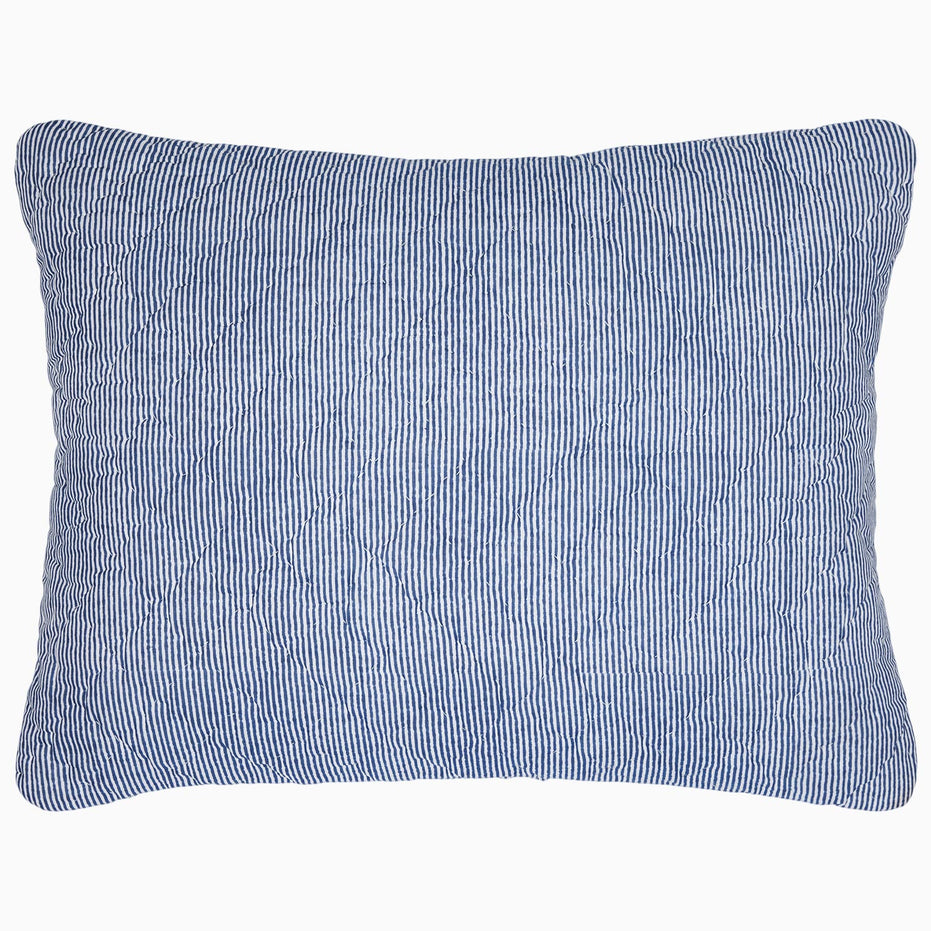 A Nandi Indigo Quilt pillow with simple stripes by John Robshaw.