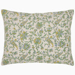A Tiya Periwinkle Woven Quilt by Quilts & Coverlets, hand quilted, green and yellow floral pillow adorned with ornate vines on a white background. - 30395666464814