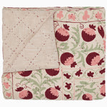 A Tejal Berry Throw by Throws, a pink and green quilt with pomegranate flowers on it, featuring diamond pattern stitching. - 30395669708846