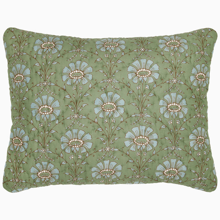 The Jeeva Sage Quilt by John Robshaw is a rectangular pillow with a green background, featuring a pattern of large blue and white flowers with intricate stems and leaves, reminiscent of a spring meadow design. This soft cotton quilted piece is both charming and cozy.