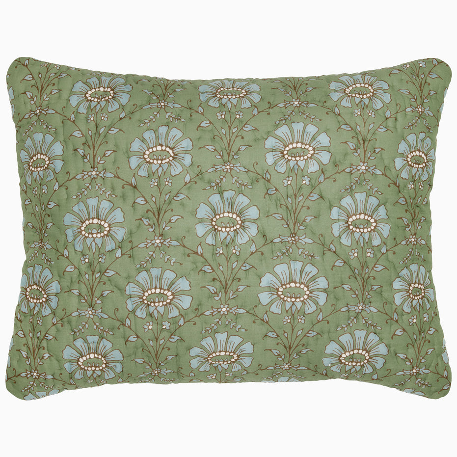 The Jeeva Sage Quilt by John Robshaw is a rectangular pillow with a green background, featuring a pattern of large blue and white flowers with intricate stems and leaves, reminiscent of a spring meadow design. This soft cotton quilted piece is both charming and cozy.