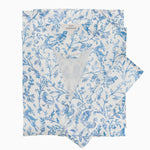 A folded robe with a light indigo floral pattern and a visible label reading 