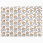 The image features the Sabah Metallic Placemats from John Robshaw, showcasing a repeating design of yellow flowers and gray foliage on a white background, created in India using block printed floral motifs. - 31272676818990
