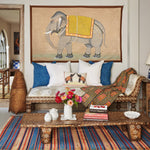 A vintage living room with a colorful rug from India and a John Robshaw Elephant with Yellow Howdah Tapestry. - 30720448495662