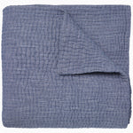 A super fine Vivada Indigo Woven Quilt blanket, expertly hand stitched and neatly folded on top of itself.  - 30252475187246