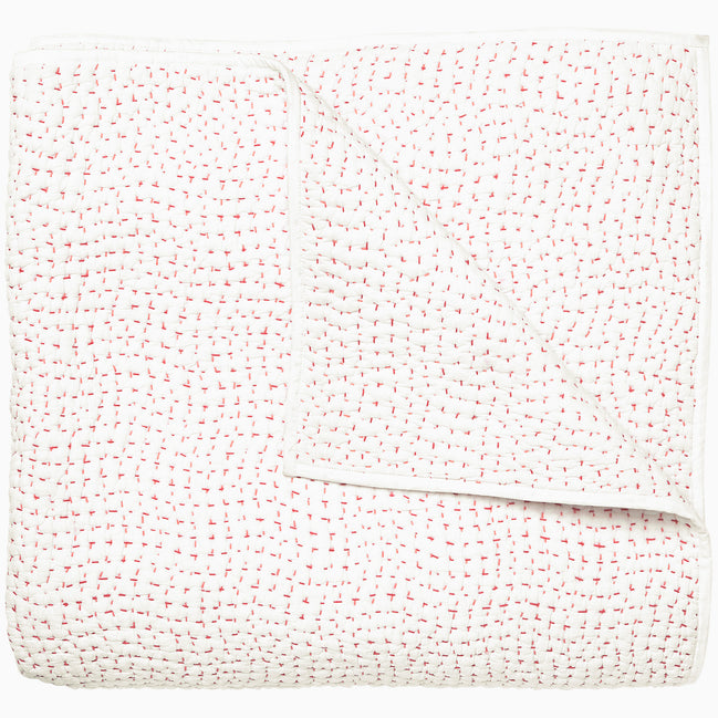 A white and pink Organic Hand Stitched Lotus Quilt with dots, by John Robshaw.