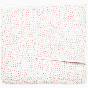 A white and pink Organic Hand Stitched Lotus Quilt with dots, by John Robshaw.