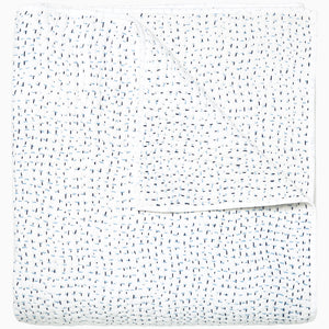 A white Organic Hand Stitched Light Indigo Quilt with blue dots on it, made with hand stitching and cotton voile, by John Robshaw.