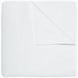 An Organic Hand Stitched White Quilt by John Robshaw folded on top of a white surface.