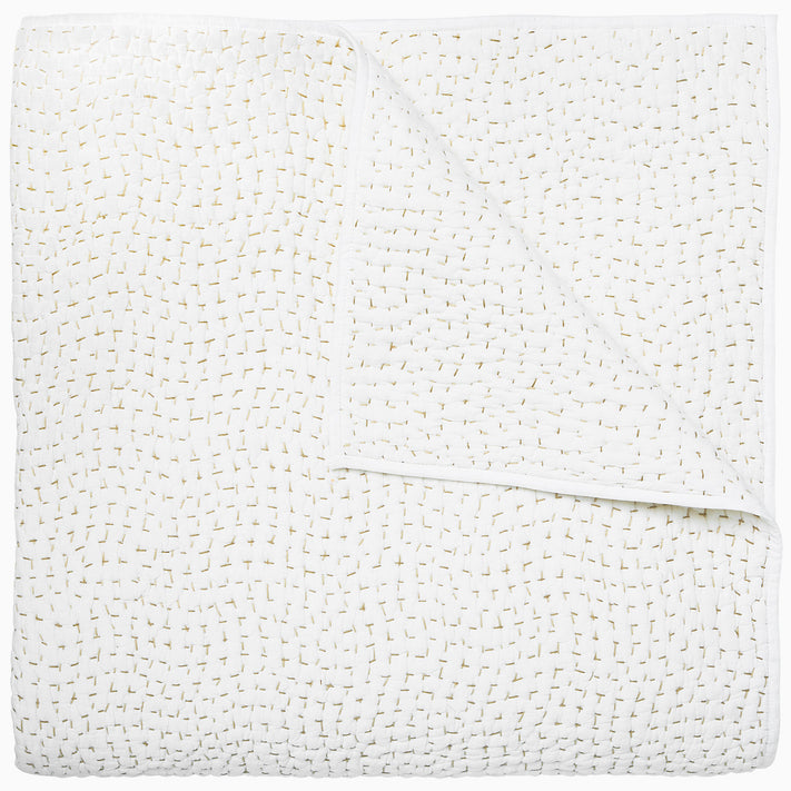 A white cotton voile coverlet featuring John Robshaw's Organic Hand Stitched Sand Quilt with subtle white dot patterns.