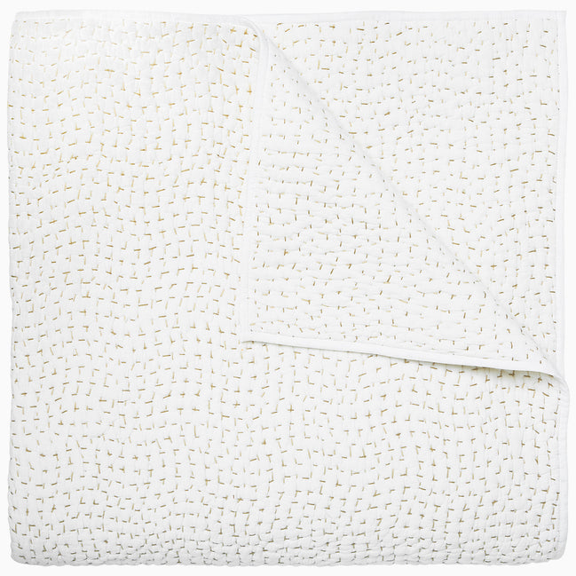 A white cotton voile coverlet featuring John Robshaw's Organic Hand Stitched Sand Quilt with subtle white dot patterns.