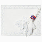A Stitched Light Indigo Placemat with a blue and red pattern on it made of machine washable cotton slub by John Robshaw. - 29333345337390