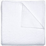 A Vivada White Woven Quilt by John Robshaw folded on top of a white surface with hand stitching. - 29300212727854
