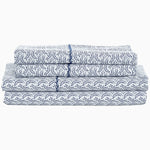 A stack of Ramra Indigo Organic Sheets by John Robshaw featuring an indigo print. - 29299676610606