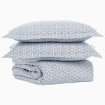 A stack of Ramra Indigo Organic Duvet pillows by John Robshaw on top of each other. - 29300087259182