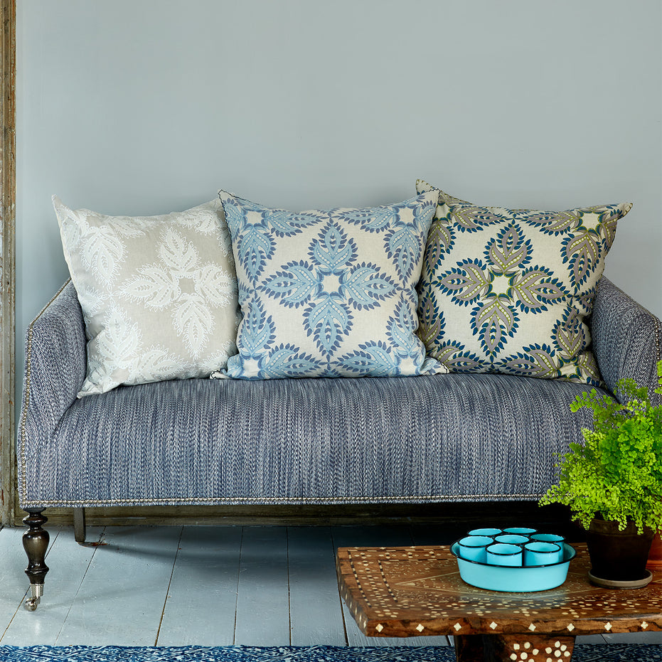 A Verdin Lapis Euro couch with John Robshaw blue pillows and a hand block printed potted plant.