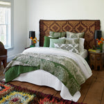 A bedroom with hand block printed Verdin Dark Sage Bolster bedding, complemented by a dark sage print rug by John Robshaw. - 29306605010990