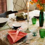 A Tabletop hand printed tablecloth with Aina Coral Napkins (Set of 4) as a vibrant place setting. - 29311354863662