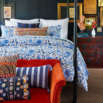 A John Robshaw Vintage Stripe Indigo Lumbar Pillow in a bedroom. - 30256477798446