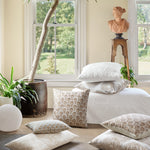 A room with white Nisha Euro pillows and a potted plant. - 30009696288814