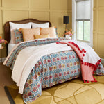 A bed with Atulya Marigold decorative pillows and a John Robshaw hand block printed comforter. - 30009699303470