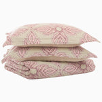 A stack of Dasati Lotus Duvet Sets by Duvets & Shams with pink accents on top of each other. - 28736039977006