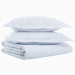 A stack of Vamika Periwinkle Organic Duvet pillows printed on organic cotton, by John Robshaw. - 28739385655342