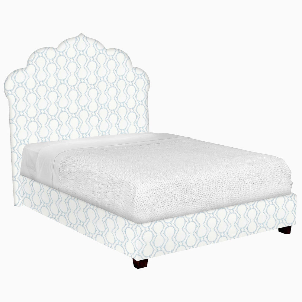 A John Robshaw custom Bihar bed with a blue patterned fabric headboard and footboard.