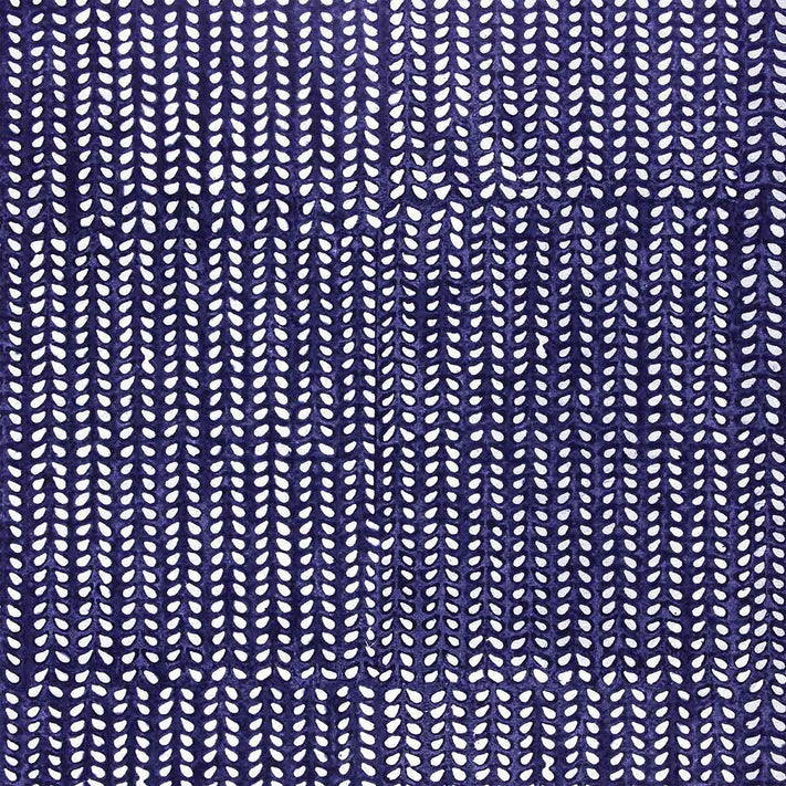 an Aleppo Indigo Wallpaper by John Robshaw with a blue and white pattern