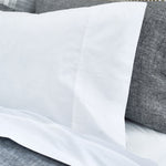 An image of a bed with John Robshaw's Anketi White Organic Sheet Set and pillows. - 15572974567470