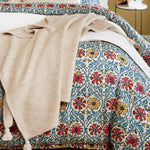 A Chahan Throw blanket with tassels on a bed. (Brand Name: John Robshaw) - 30060640600110