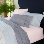 A 100% cotton percale bed with blue, pink, and white bedding, including a John Robshaw Cinde Light Indigo Organic Sheet Set. - 29299616874542
