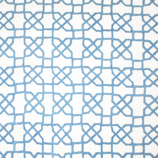 A blue and white pattern adorned with Mughal motifs on a white background, expertly crafted using traditional techniques of hand block printing, featuring the Citadel Light Indigo Fabric by John Robshaw.