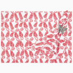 A red and white John Robshaw gift wrap with ferns on it, featuring springlike colors. - 29998916141102