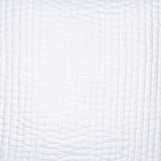 A close up of a Vivada White Woven Quilt Swatch crocodile skin pillow by John Robshaw.