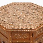 A hand inlayed octagon shaped wooden table with a Natural Bone Inlay Table design by John Robshaw. - 29553992728622