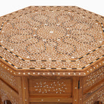 A hand inlayed octagon shaped wooden table with a Natural Bone Inlay Table design by John Robshaw. - 29553992728622