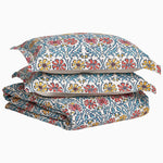 A stack of Yuvan Duvet Sets by John Robshaw with a floral pattern and block print on them. - 29980993159214