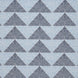 A Farzu Azure Performance Fabric rug with blue and white triangles on it by John Robshaw.