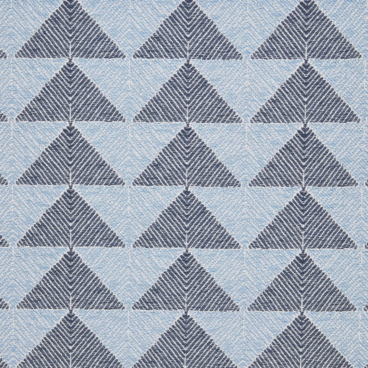 A Farzu Azure Performance Fabric rug with blue and white triangles on it by John Robshaw.