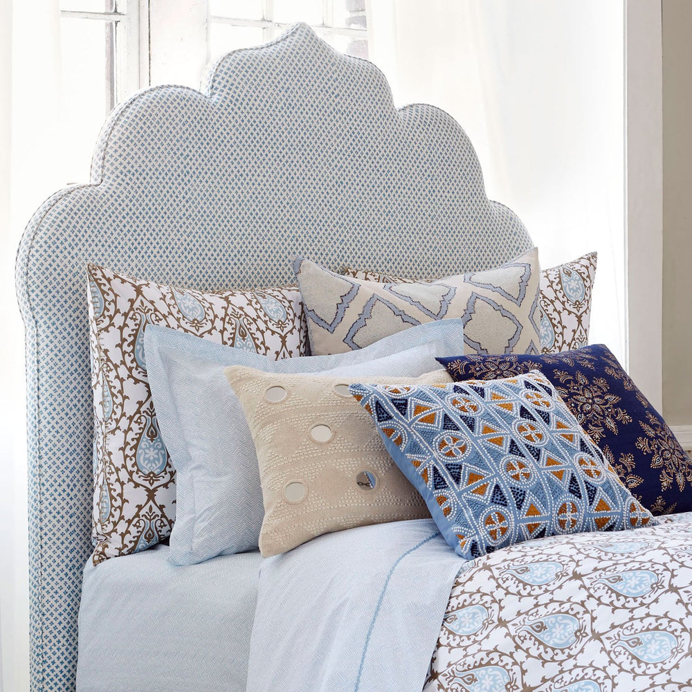 A John Robshaw handmade Custom Bihar Headboard bed with blue pillows and white glove delivery.
