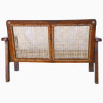 A John Robshaw Loveseat With Grid Arms bench with a rattan seat. - 29225296494638